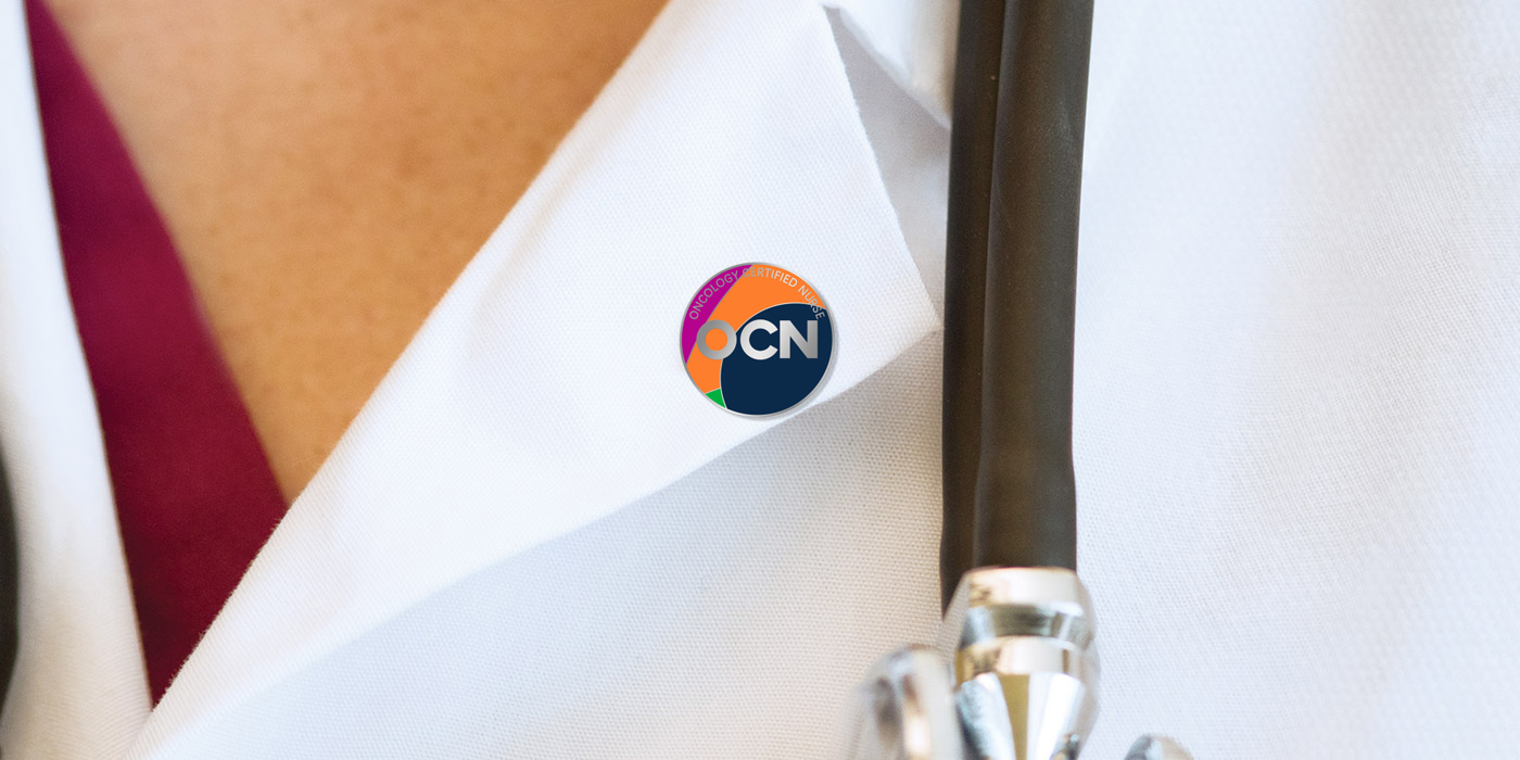 OCN pin on white coat.